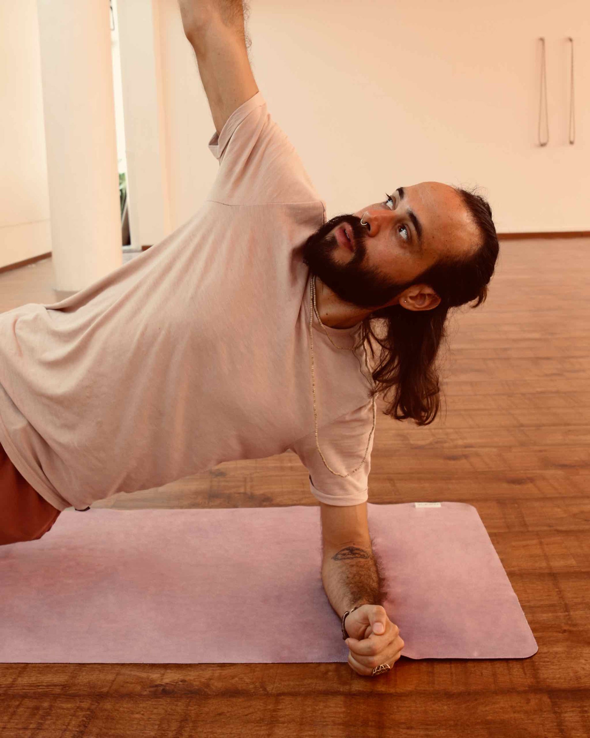 Exercise Yoga Mat-Man doing stretches on pink yoga mat-Mikkoa Melon travel yoga mat 