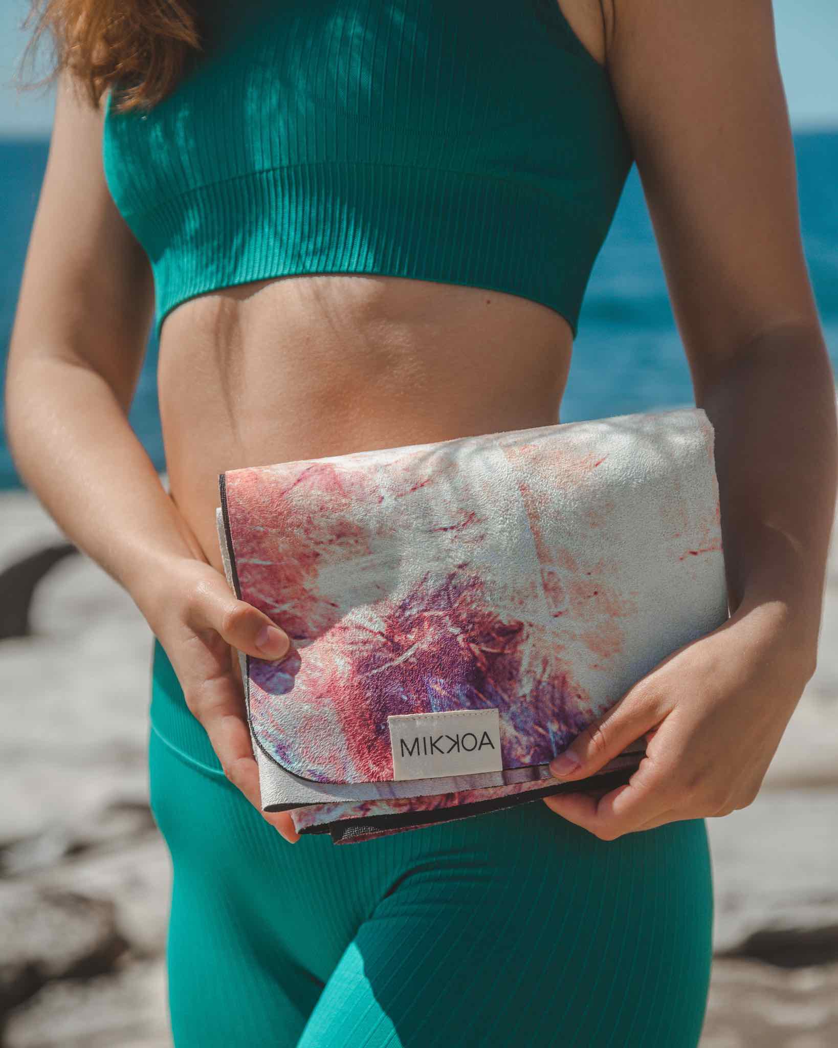 Foldable Yoga Travel Mat-Women Holding Folded Yoga Mat Image-Mikkoa Mystic Marble Travel Yoga Mat